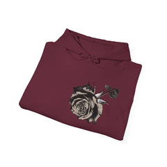 Folded maroon hoodie with black and white rose graphic on front
