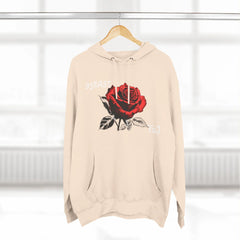 Beige hoodie with red rose graphic and 95EAST YxJ text, hanging on wooden hanger