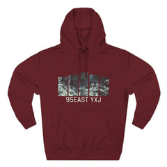 Maroon hoodie with abstract graphic panels and 95EAST YXJ text on the front