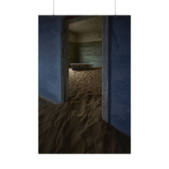 Deserted room with sand filling floor and doorway, vintage bathtub inside, peeling blue walls