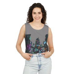 Woman wearing sleeveless gray top with colorful cityscape graphic and light denim jeans