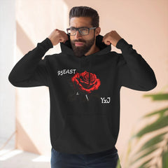 Black hoodie with red rose graphic and barcode sleeve detail, worn by man adjusting hood