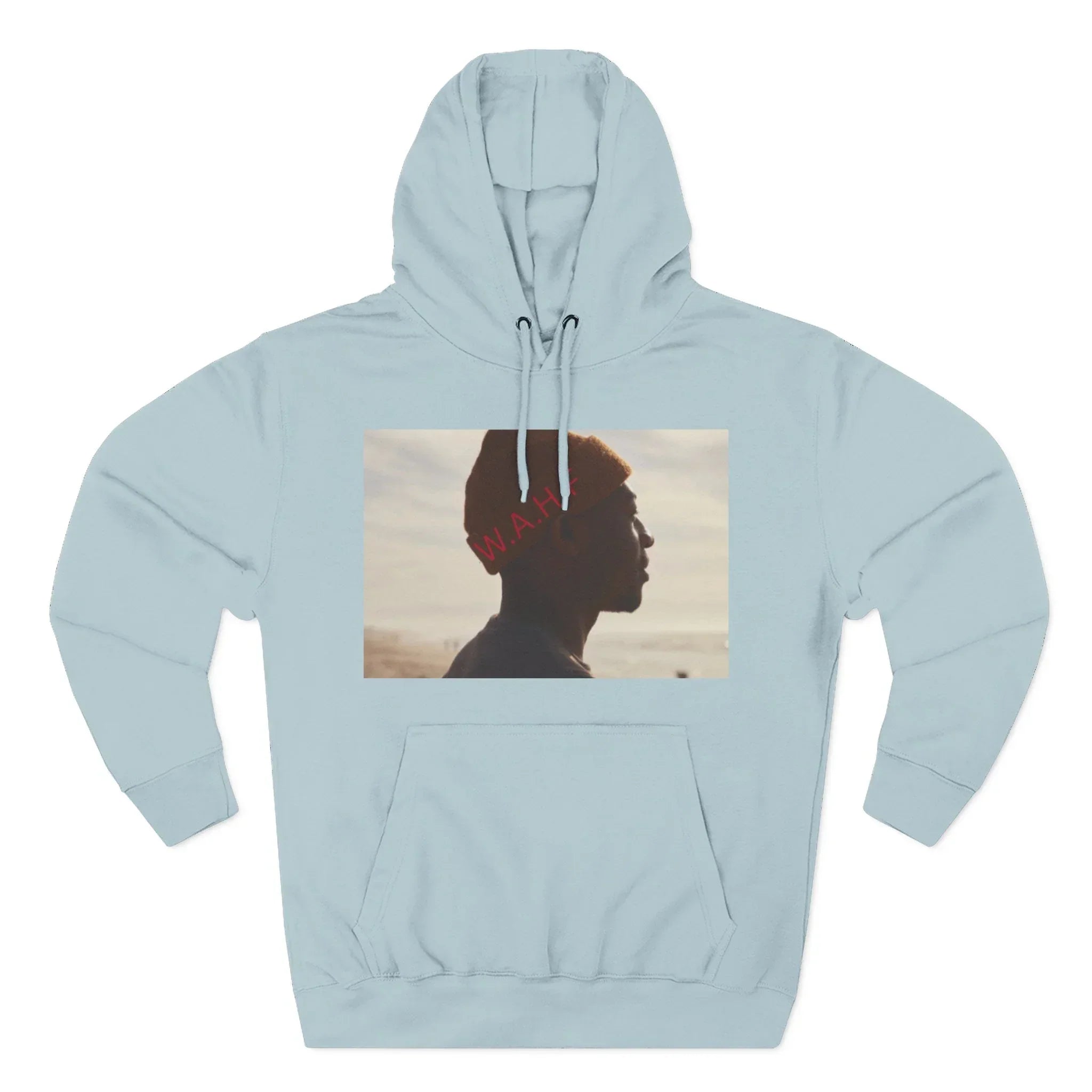 Light blue hoodie with a photo print of a person in an orange beanie at the beach, red W.A.H. text