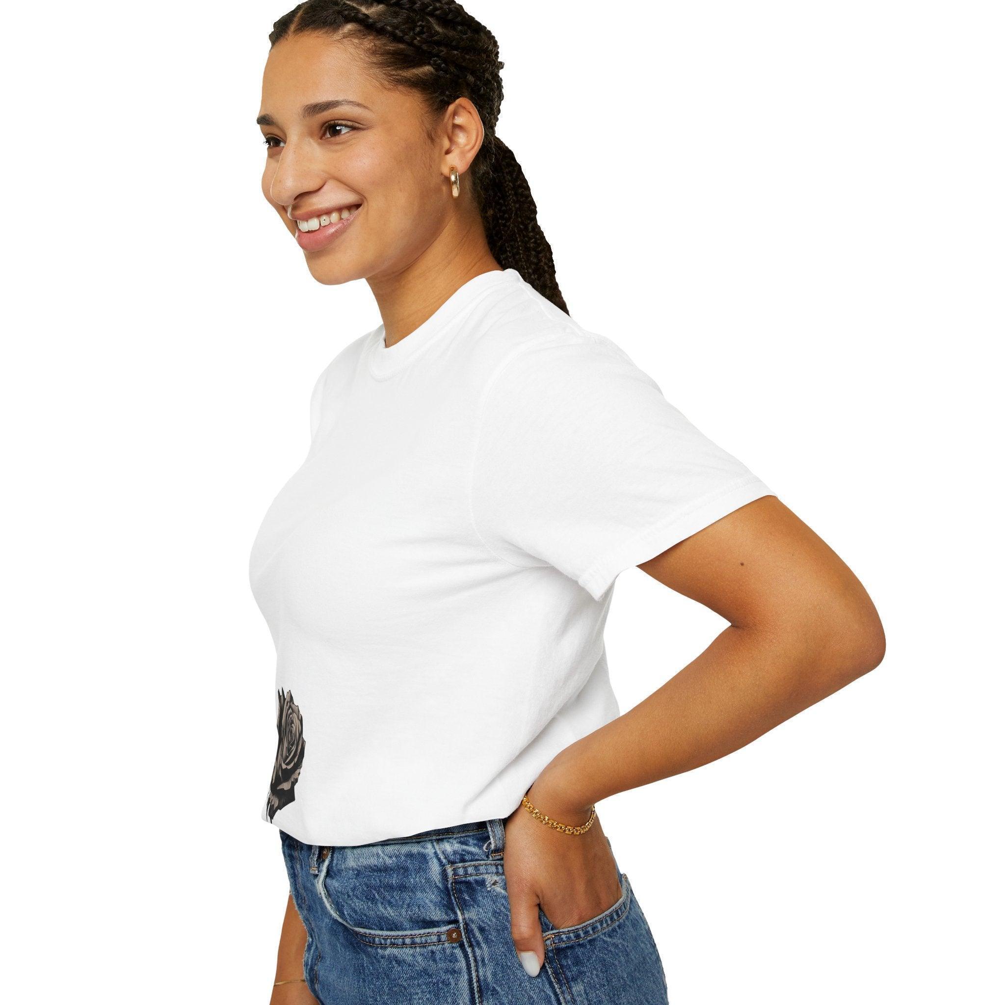 Woman wearing white t-shirt with rose graphic, paired with blue jeans, showcasing casual East Coast style.