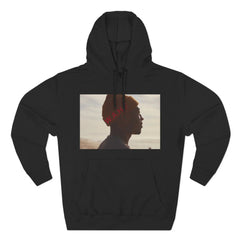 Black hoodie with a photo print of a person in profile view wearing an orange beanie