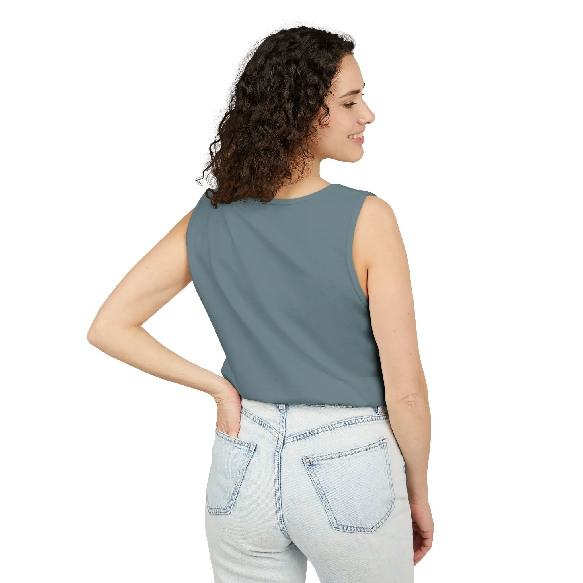 Woman wearing sleeveless blue top and light wash jeans, seen from the back