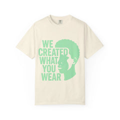 Cream t-shirt with green 'WE CREATED WHAT YOU WEAR' text and silhouette design
