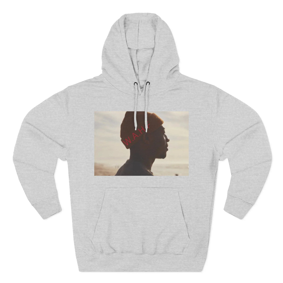 Light grey hoodie with a photo print of a person in profile wearing a red hat at the beach.