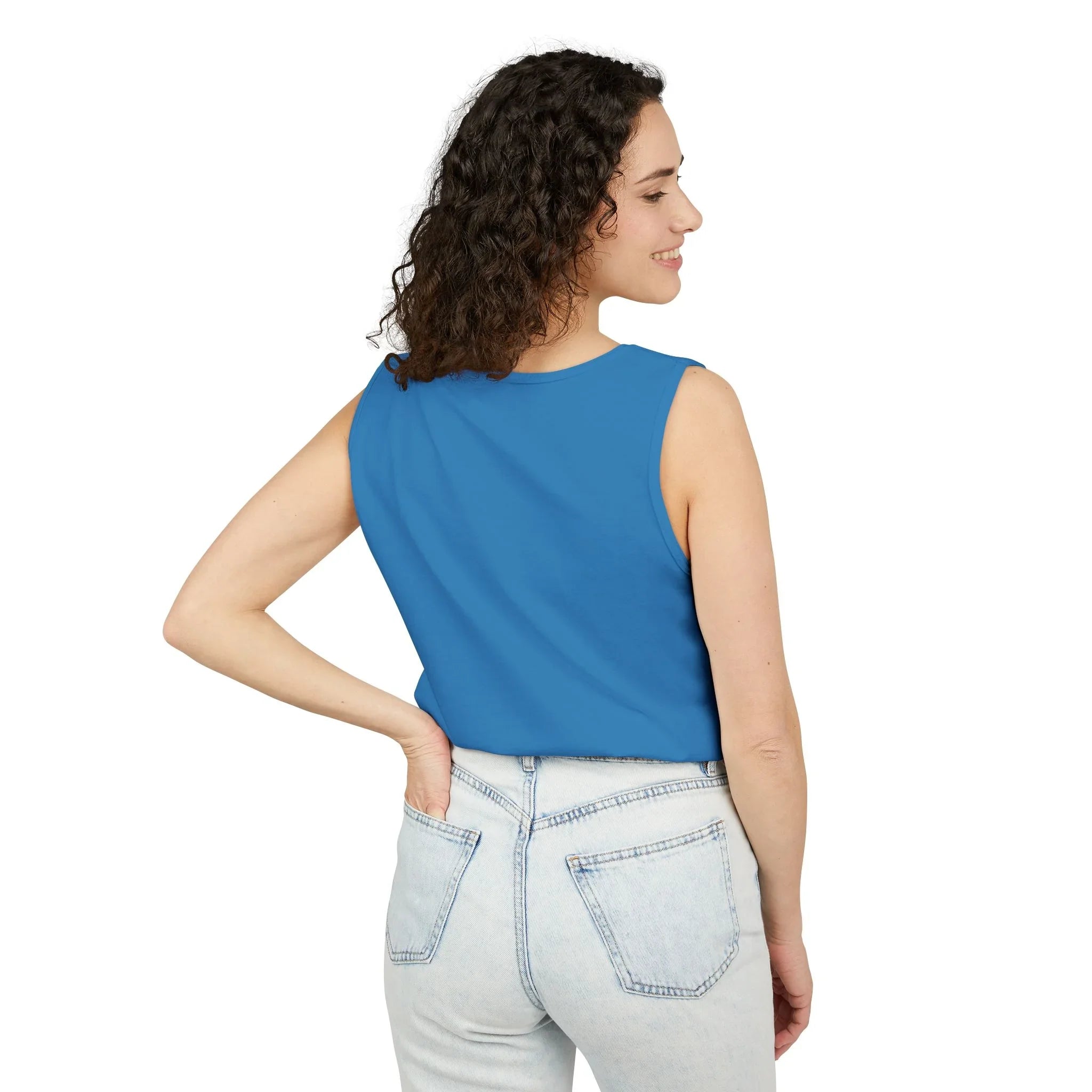 Woman in blue sleeveless top and light denim jeans, showcasing casual style