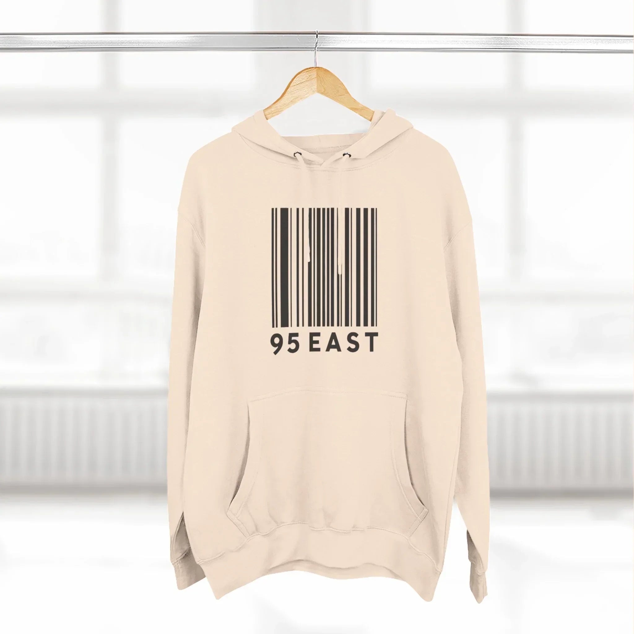 Beige hoodie with barcode design and '95 EAST' text, modern East Coast style