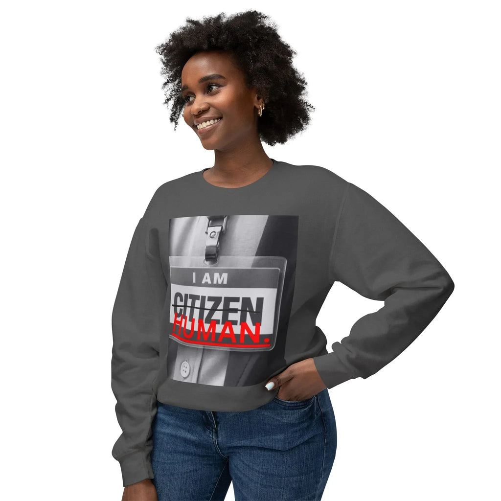 Smiling woman in dark gray sweatshirt with 'I AM CITIZEN HUMAN' badge graphic design