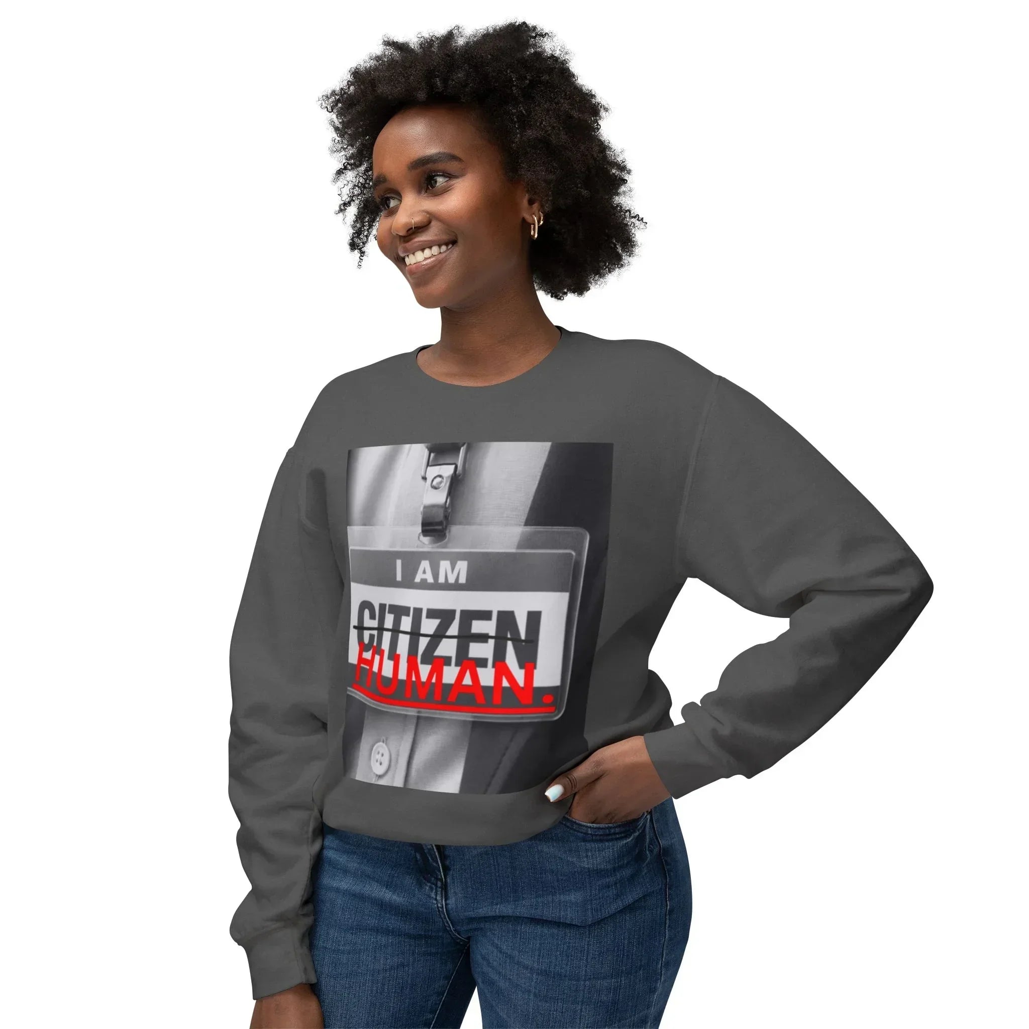 Smiling woman in dark gray sweatshirt with 'I AM CITIZEN HUMAN' badge graphic design