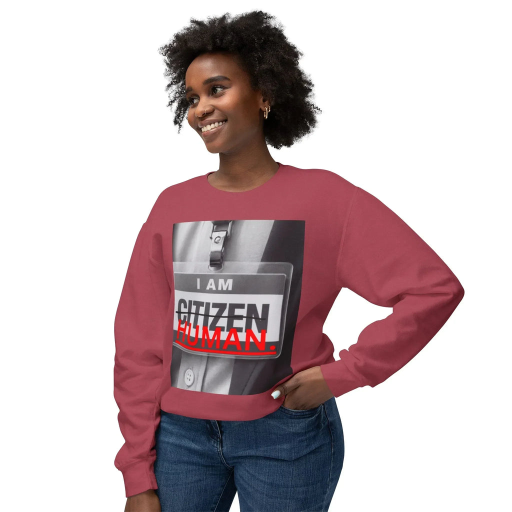 Smiling woman in a maroon sweatshirt with 'I AM HUMAN' graphic, casual fashion style
