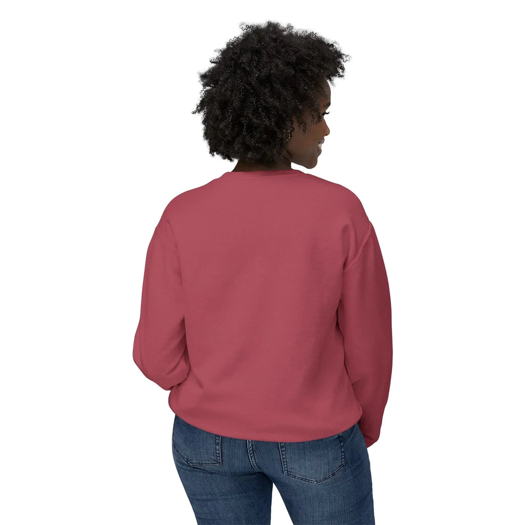 Woman wearing a rose pink crewneck sweatshirt and blue jeans, shown from the back