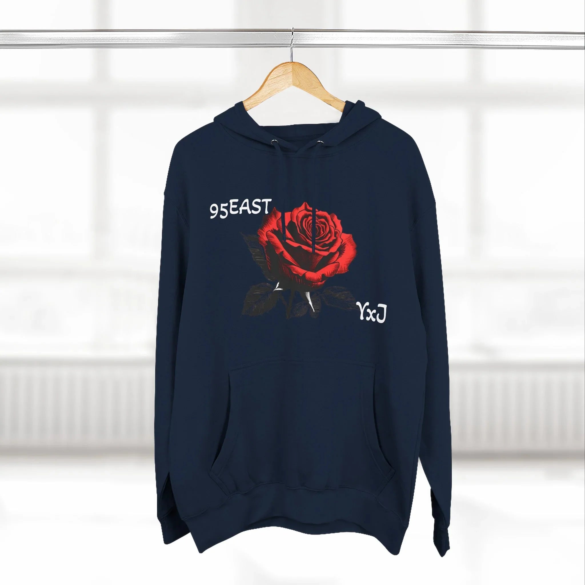 Black hoodie with red rose graphic and barcode sleeve detail, 95EAST YxJ design