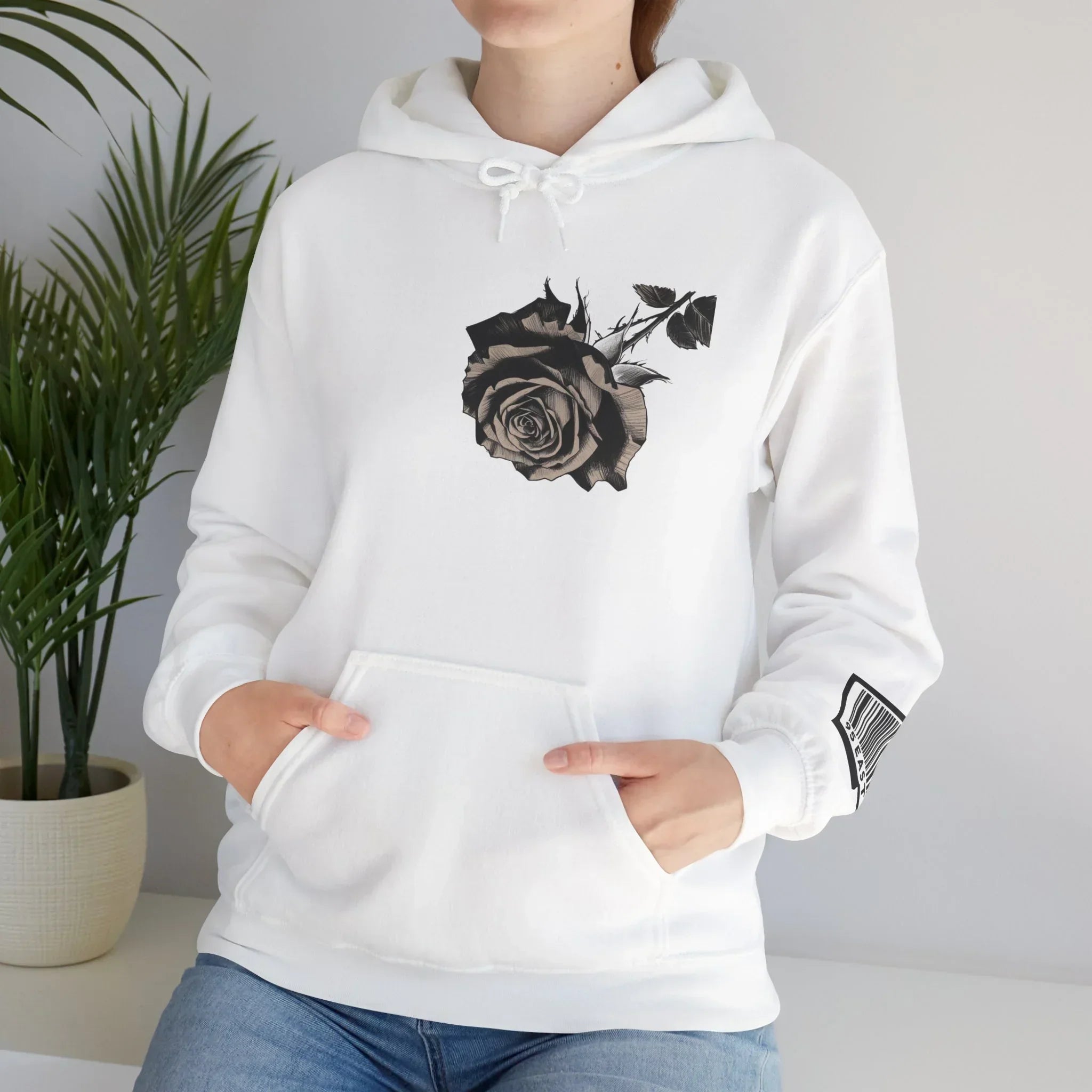 White hoodie with black rose graphic on chest and barcode design on sleeve