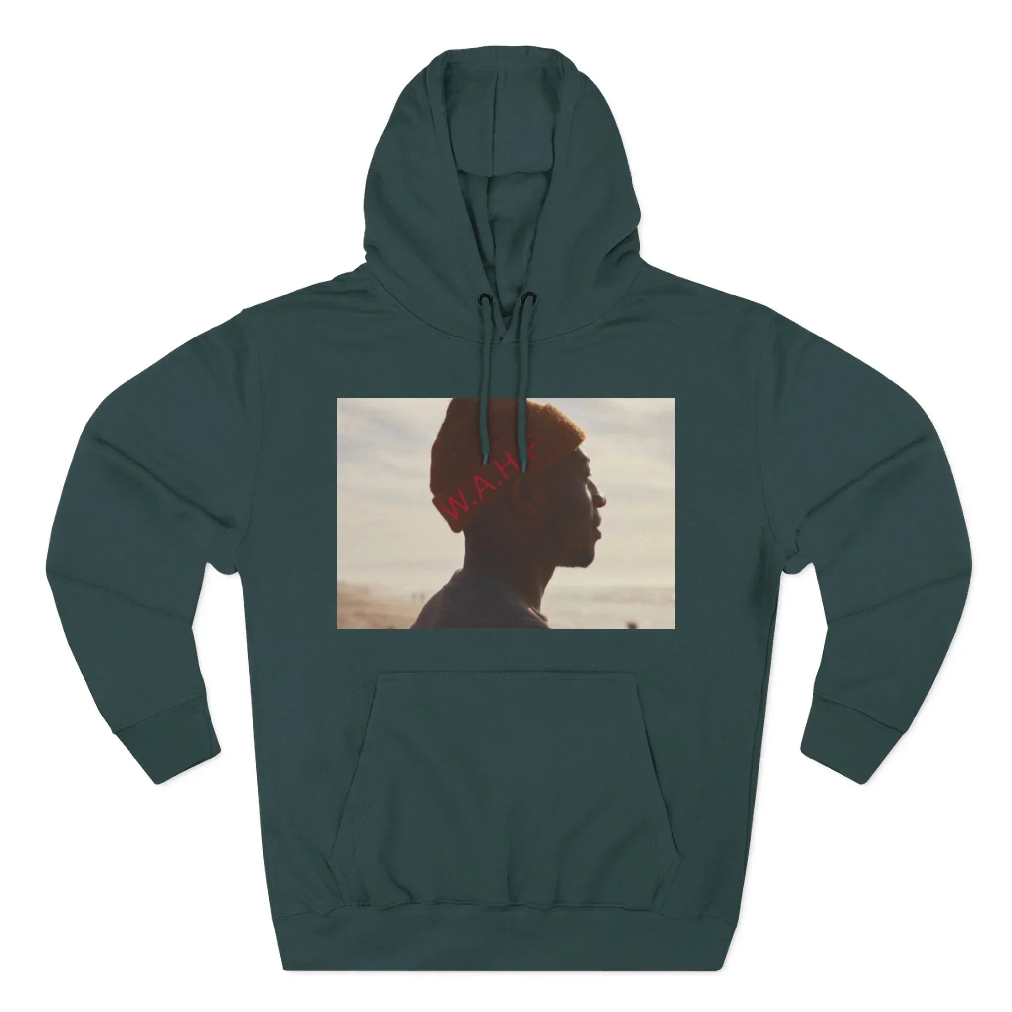Dark green hoodie with photo graphic of person in orange beanie facing left, beach background.