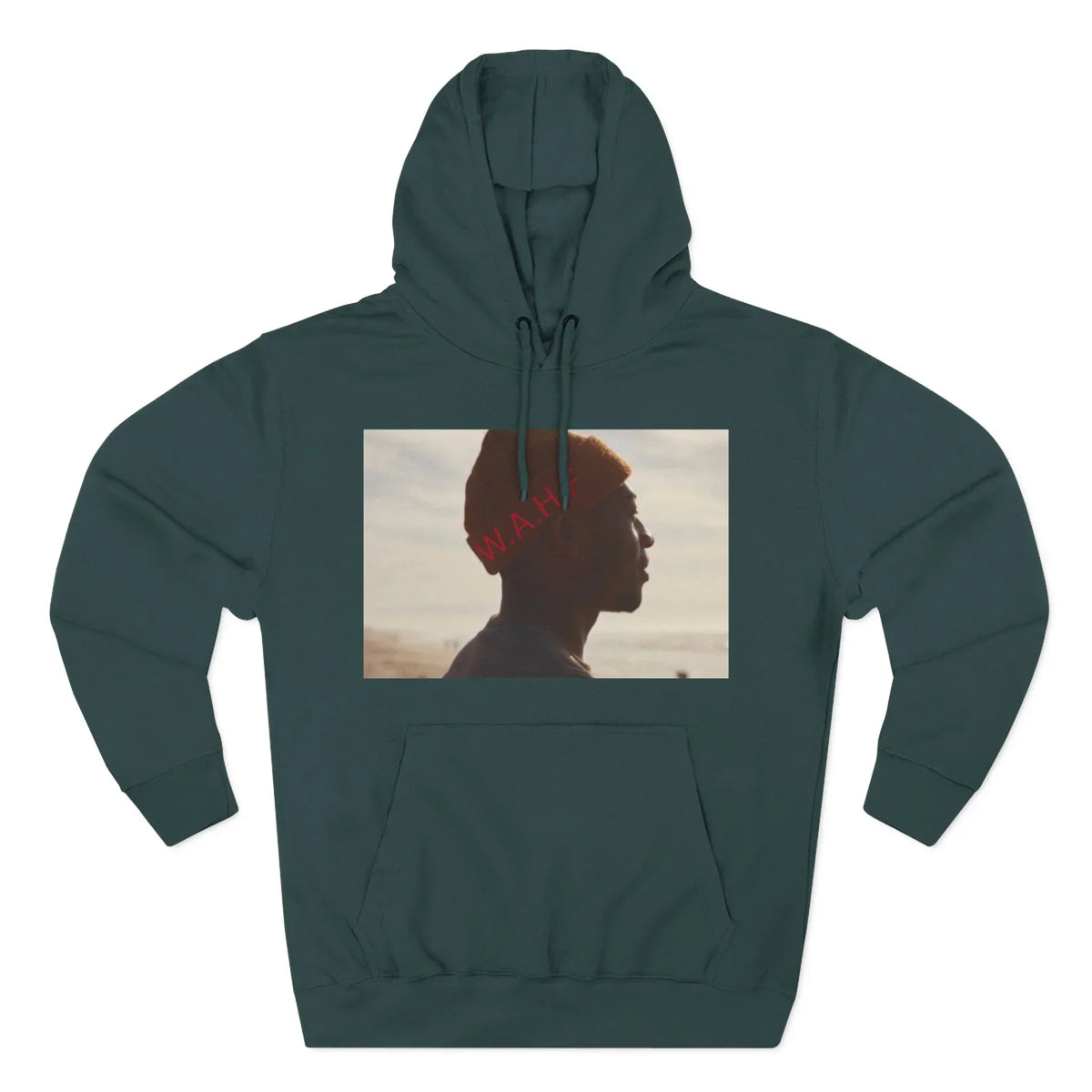 Dark green hoodie with photo graphic of person in orange beanie facing left, beach background.