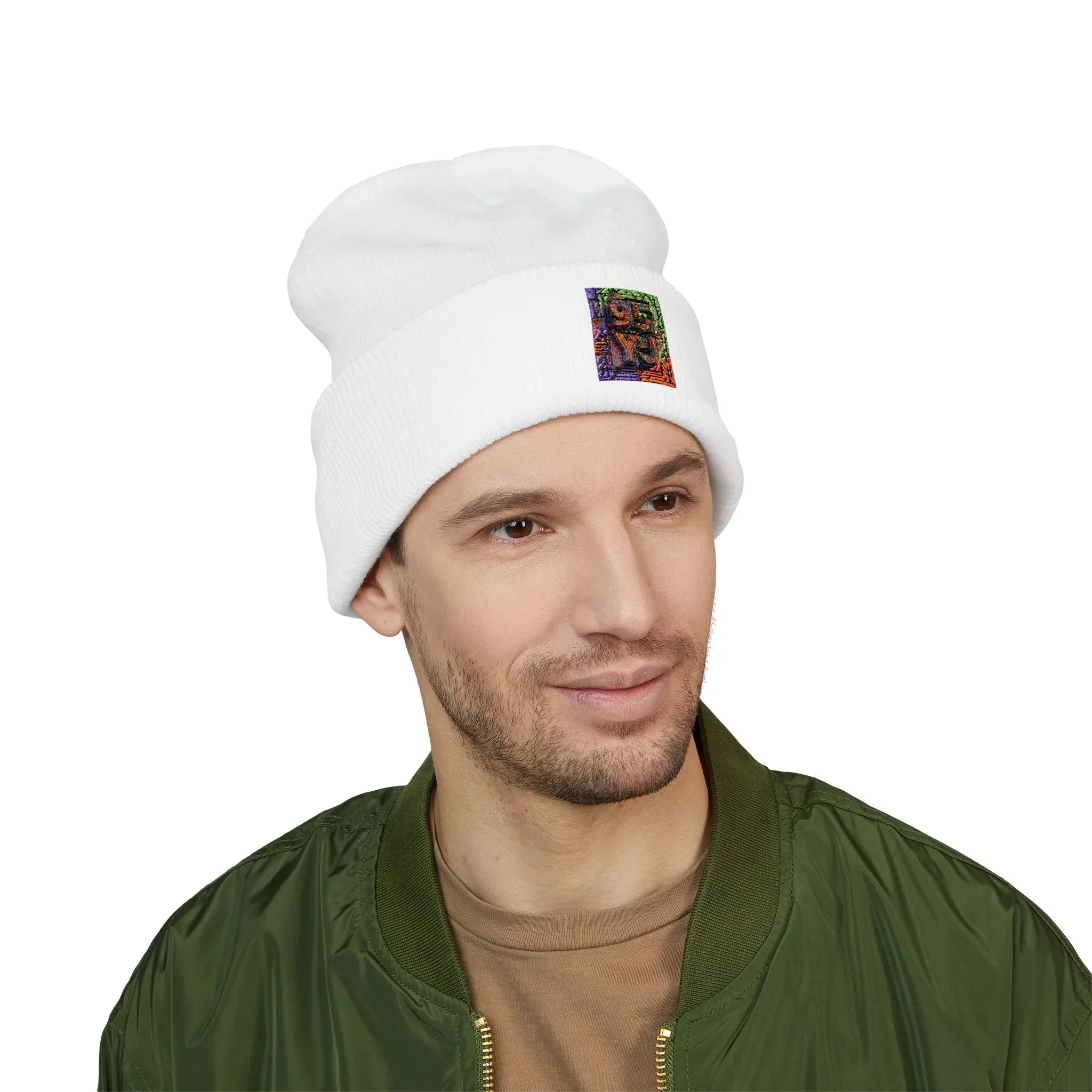 Man wearing a white beanie with colorful patch, green bomber jacket, and brown shirt