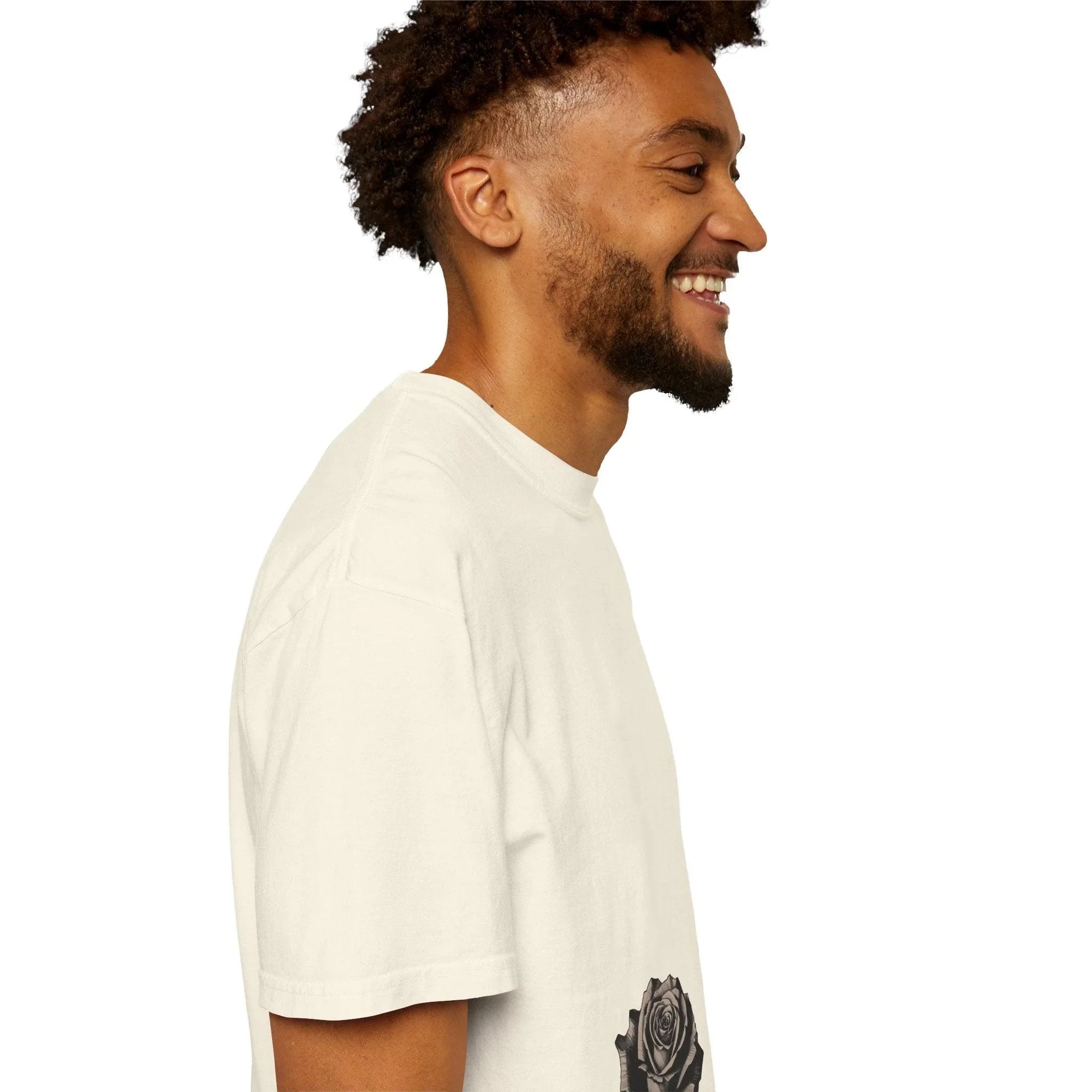 Man smiling in white t-shirt with black rose graphic, side profile view
