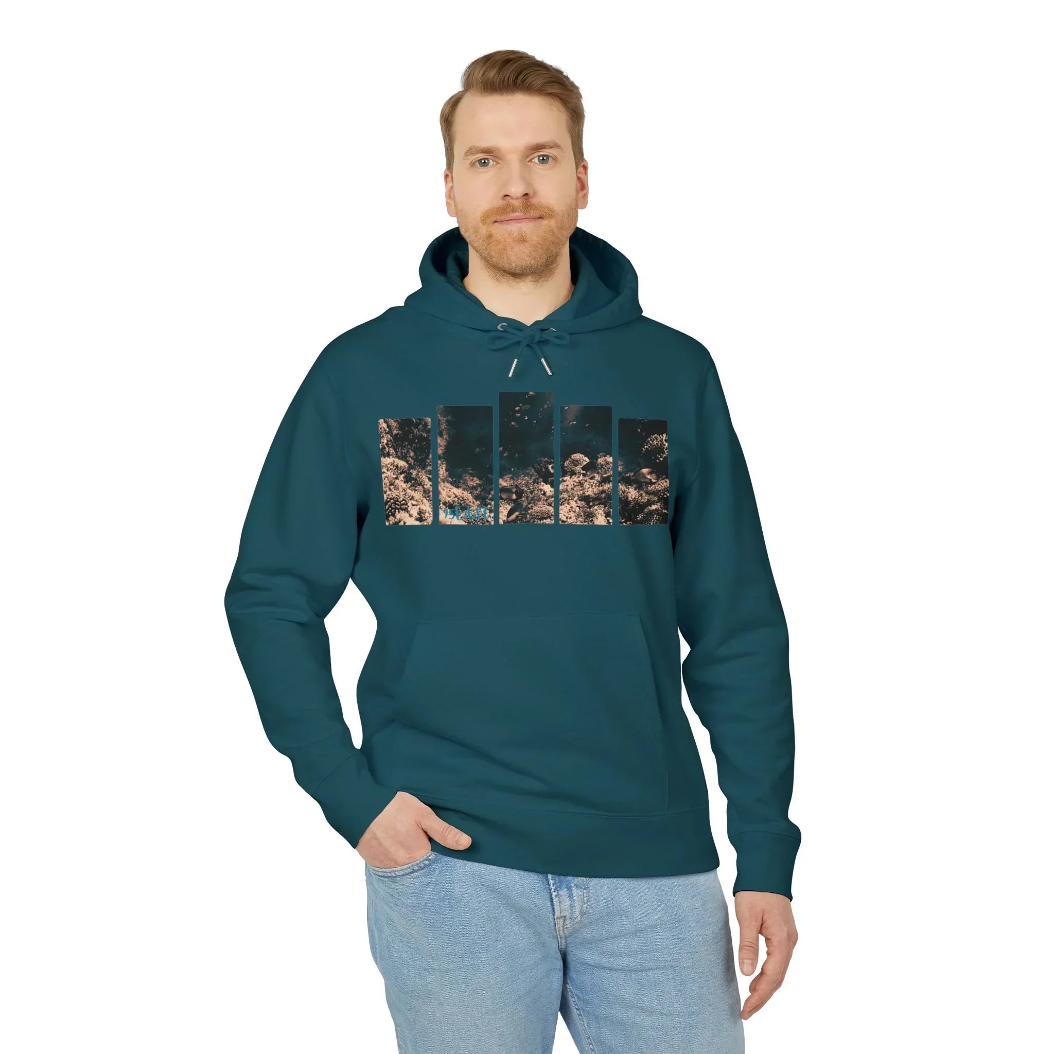Man wearing teal hoodie with coral reef print, paired with light jeans, showcasing casual coastal style.