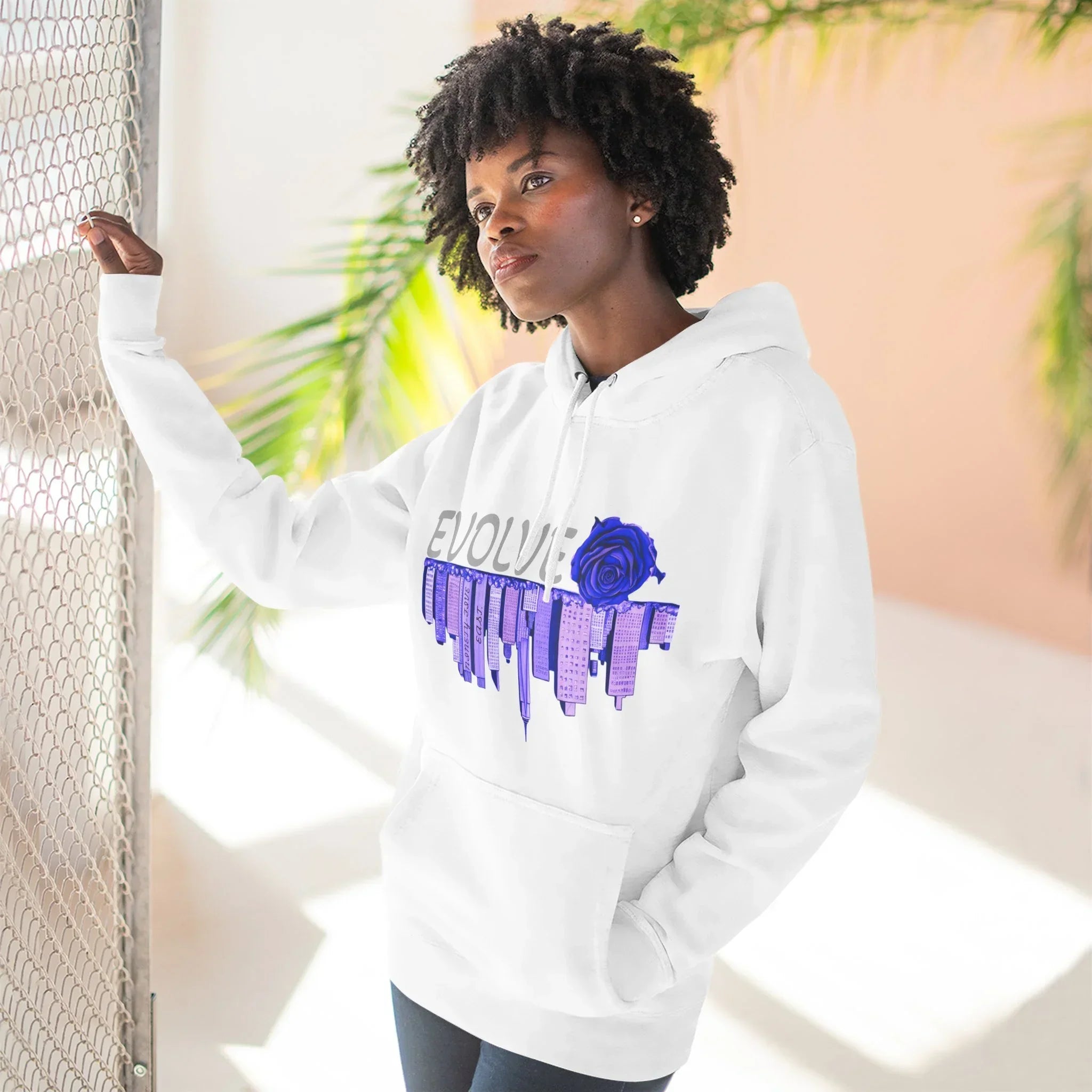 White hoodie with blue rose and city skyline graphic, urban streetwear style