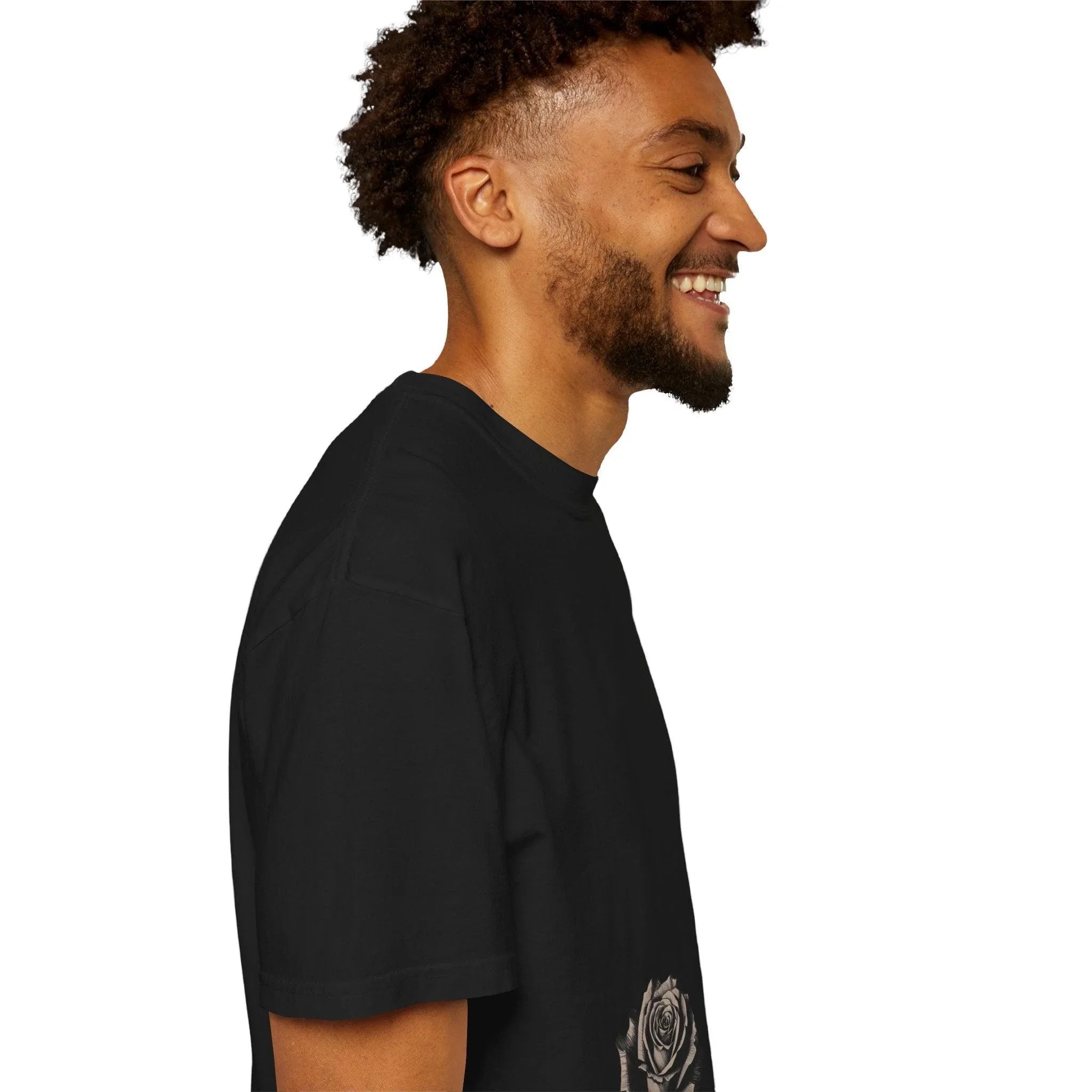 Man smiling in black t-shirt with rose graphic, side profile view