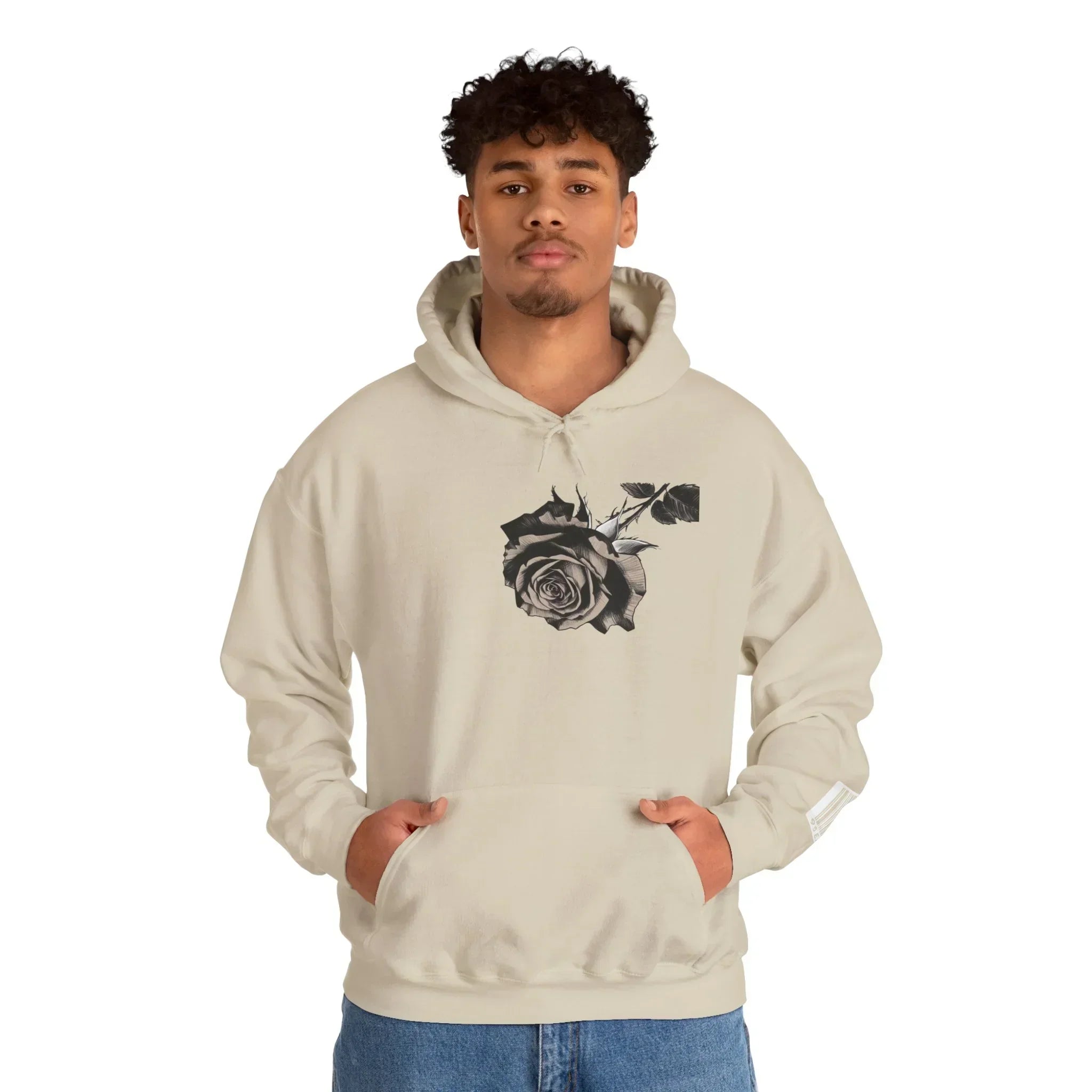 Man wearing beige hoodie with black rose graphic on chest, casual streetwear style