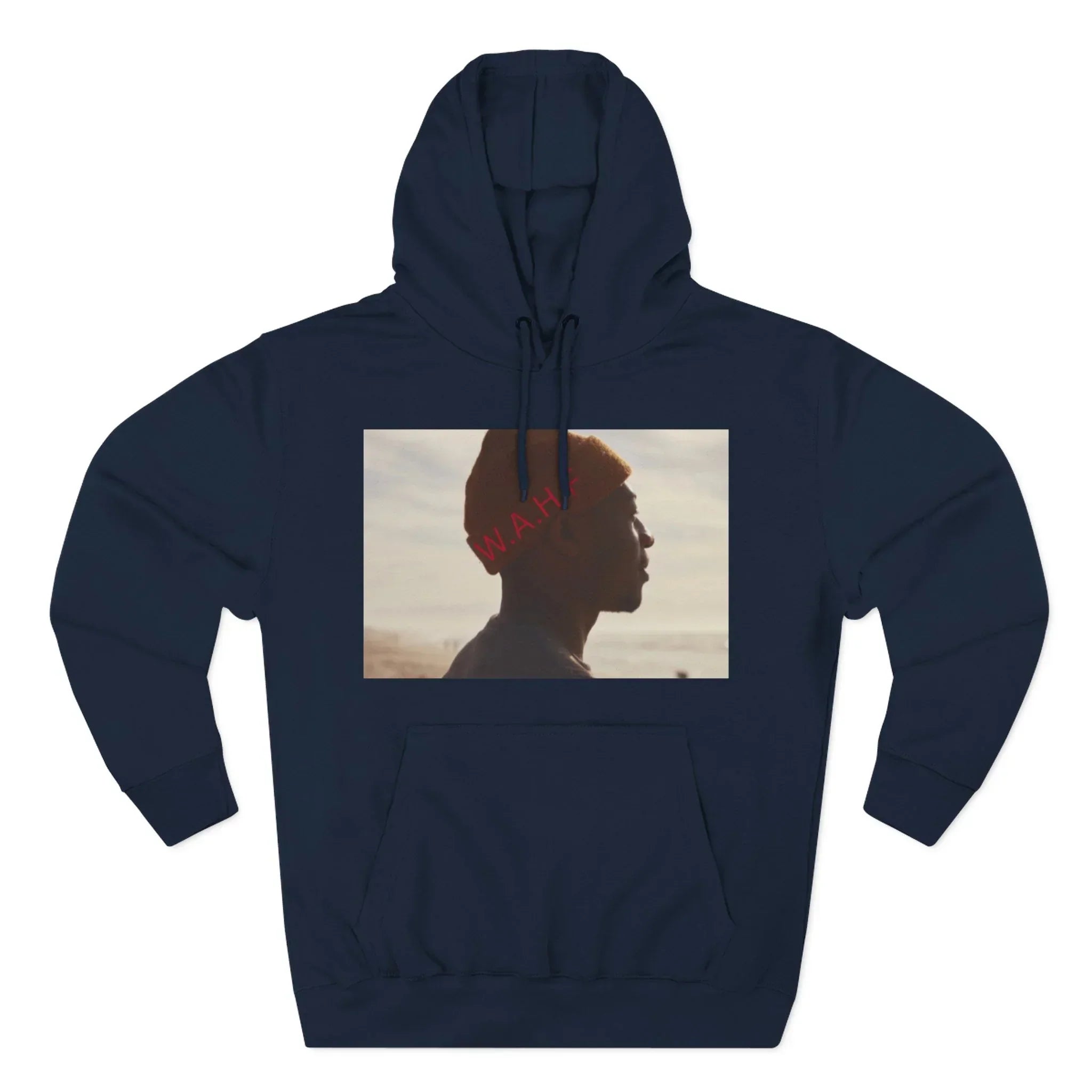 Navy hoodie with a print of a person in profile wearing an orange beanie on a beach.