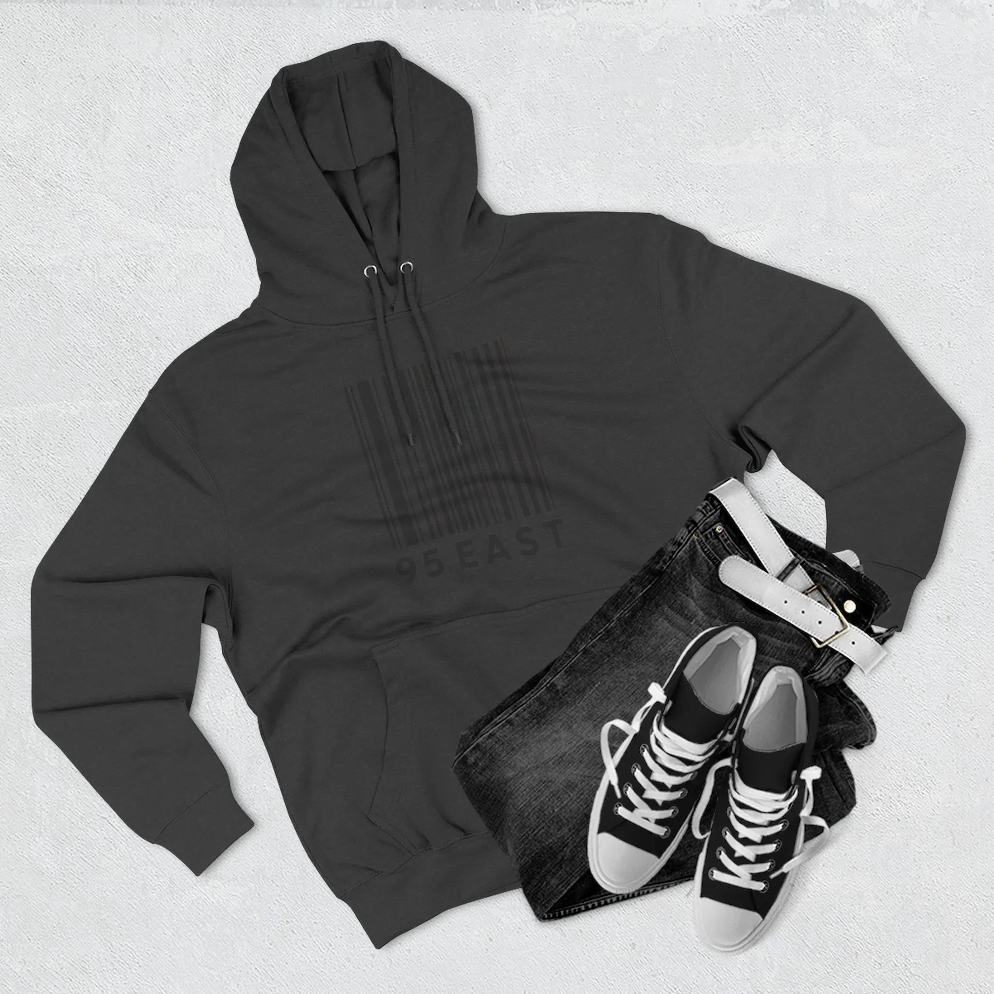 Black hoodie with barcode design, paired with jeans and sneakers for casual East Coast style