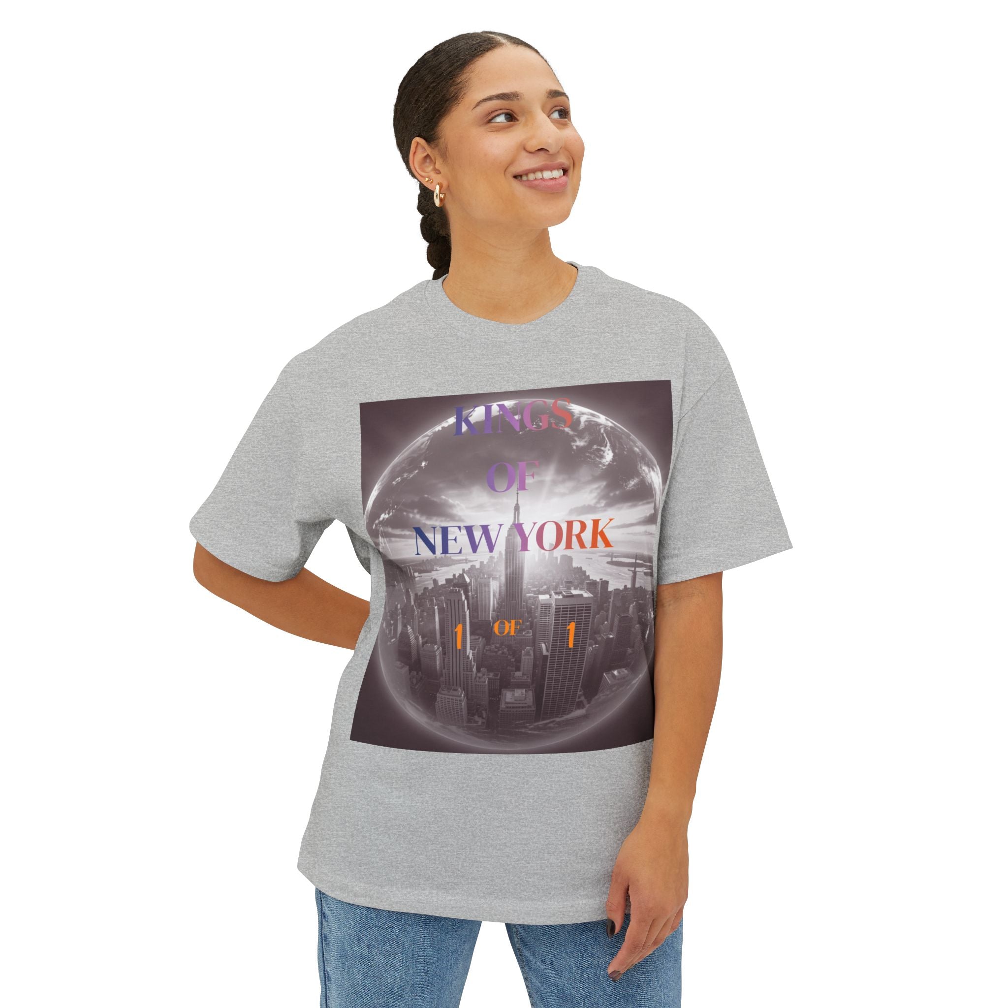 Gray graphic tee with 'Kings of New York' text over city skyline globe design, worn by woman