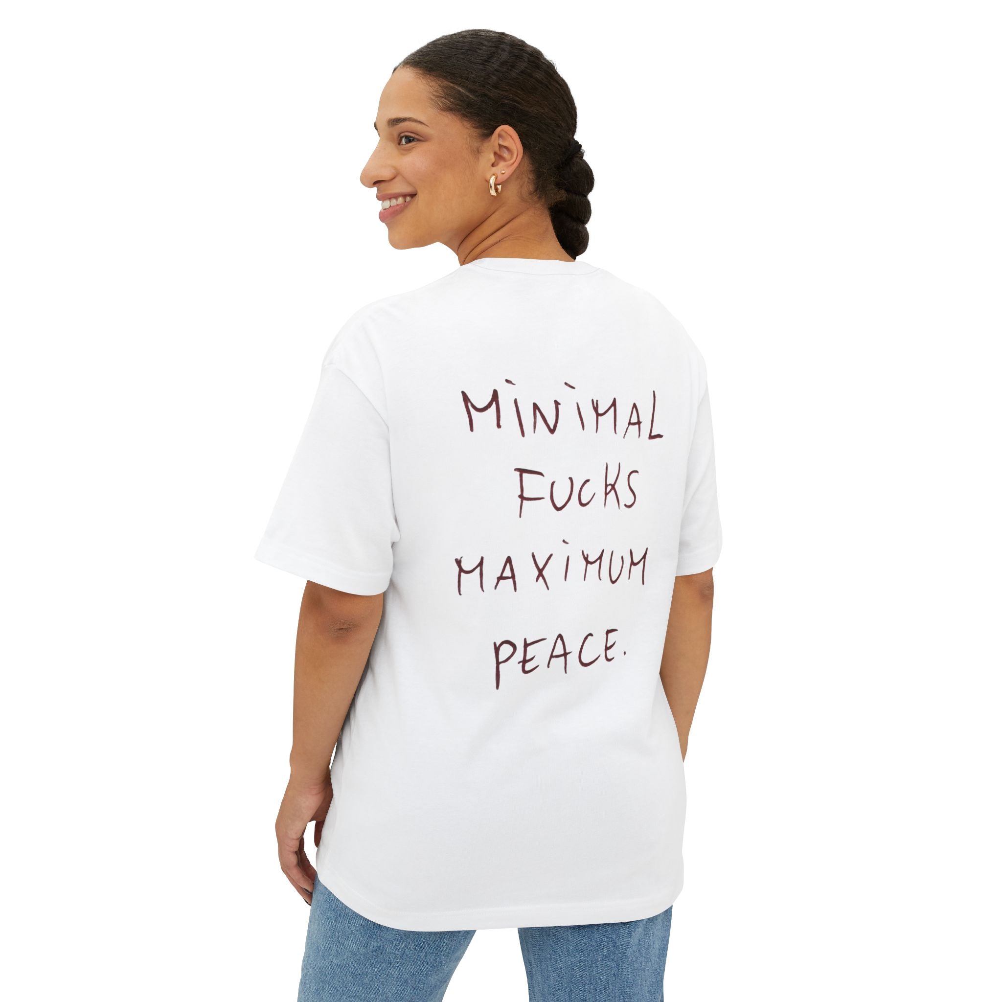 White oversized T-shirt with 'Minimal Fucks Maximum Peace' graphic text on back, worn by woman