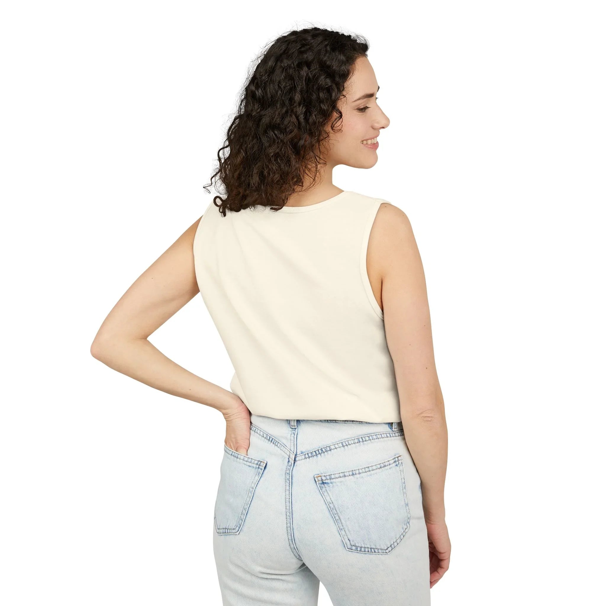 Woman in cream sleeveless top and light wash jeans, back view, casual lifestyle fashion