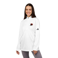 Smiling woman wearing a white quarter-zip pullover with red rose embroidery and black logo sleeve detail