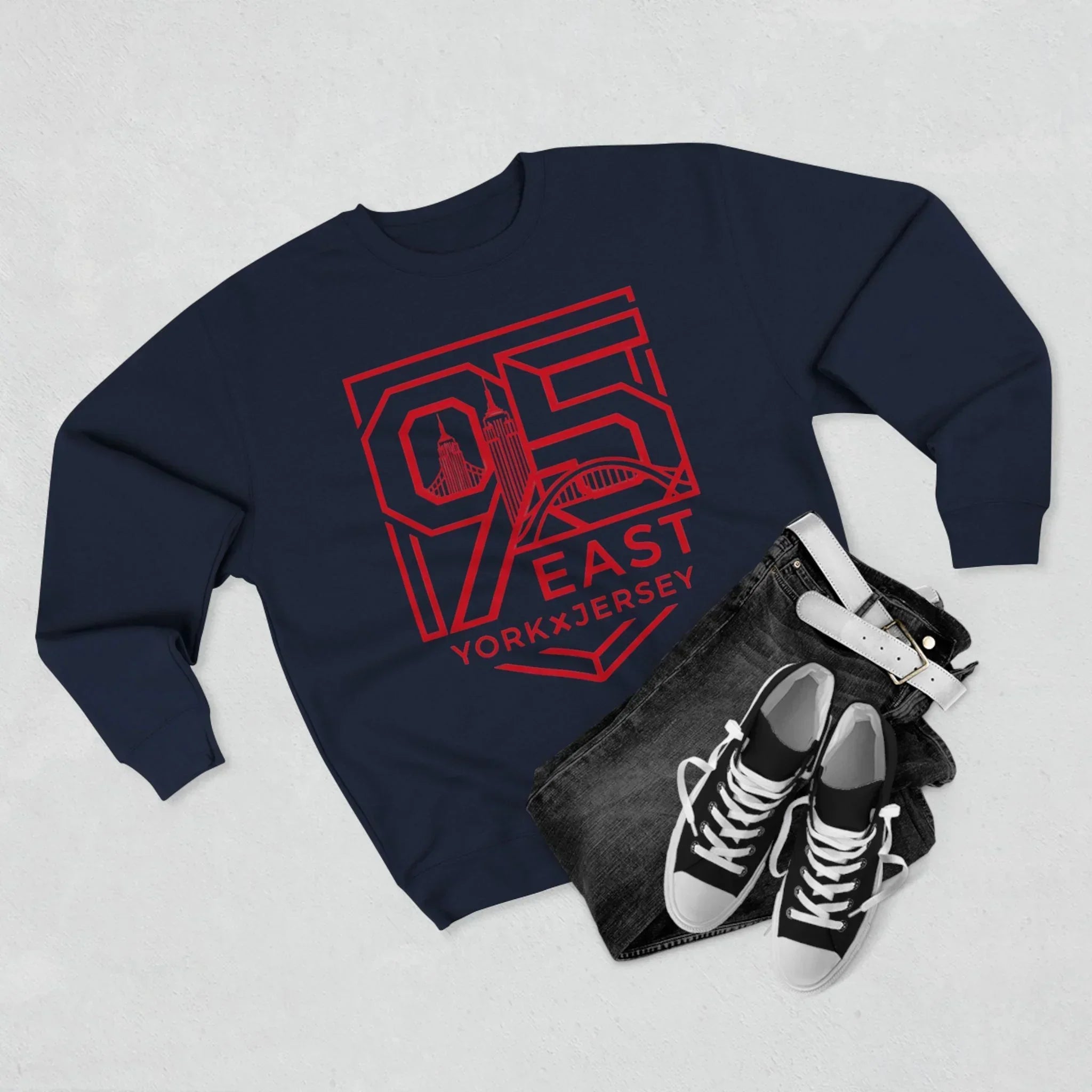 Navy hoodie with bold red 95 East YorkxJersey graphic, paired with jeans and sneakers for urban streetwear style.