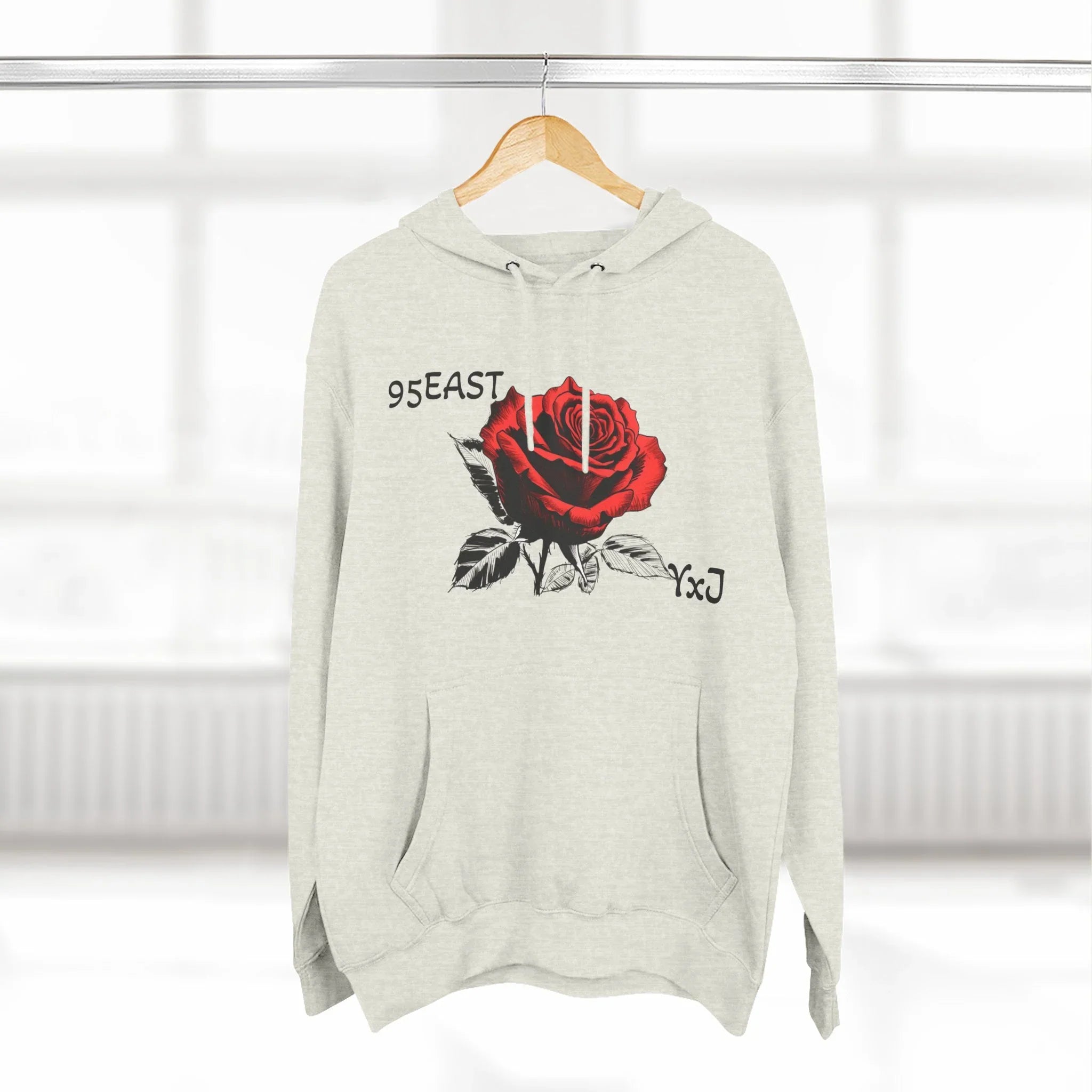 Black hoodie with red rose graphic and barcode sleeve detail, East Coast style