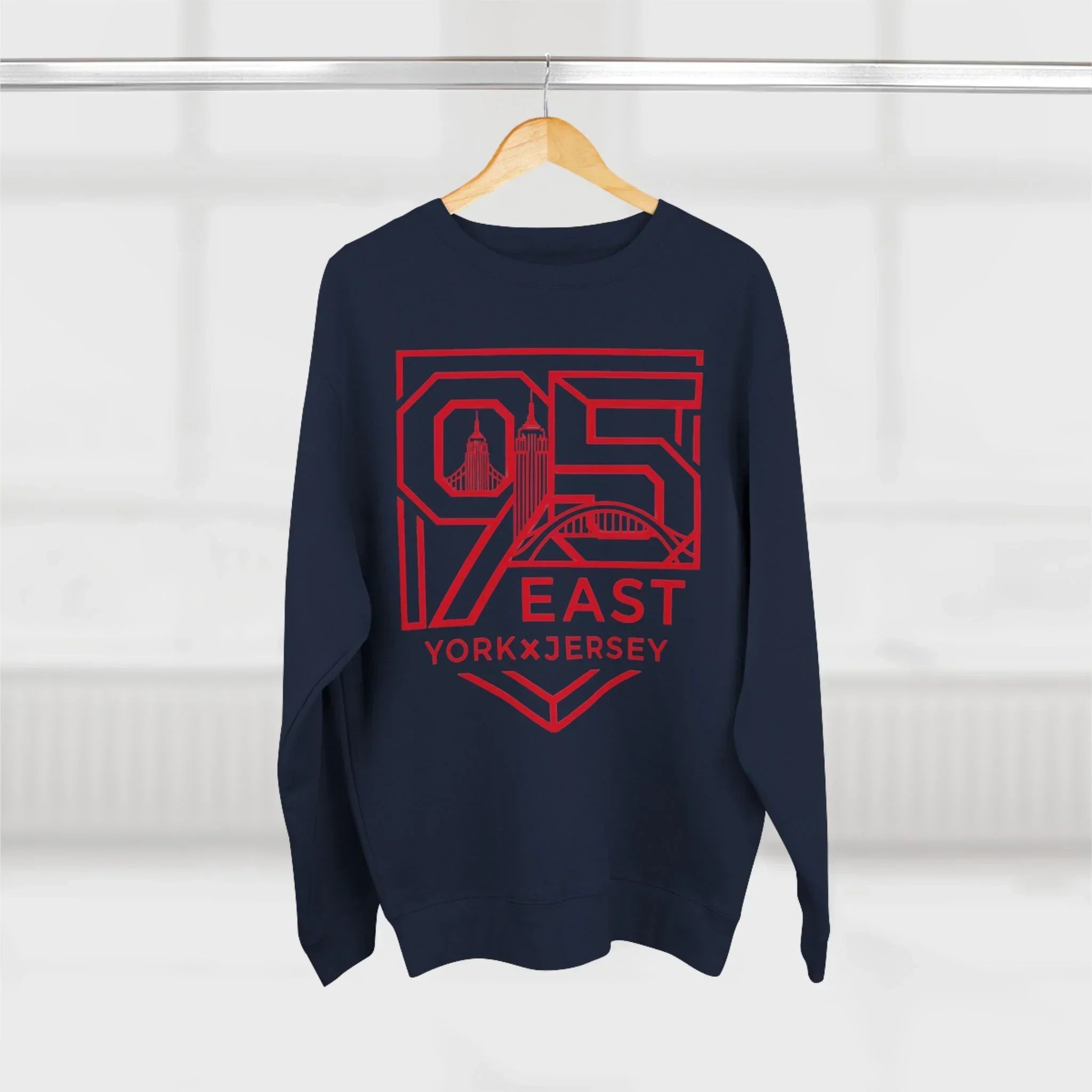 Navy hoodie with red 95 East YorkxJersey graphic, city skyline design, hanging on wood hanger