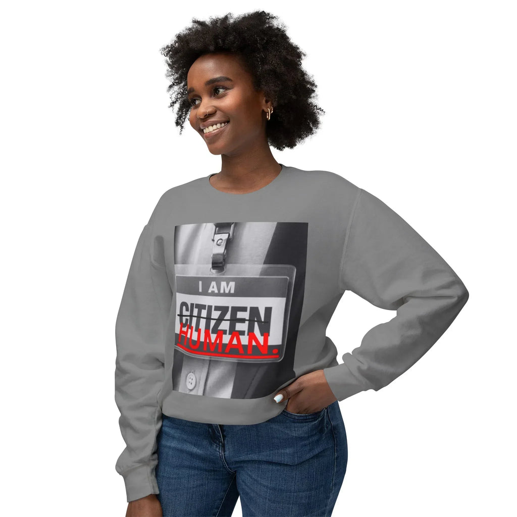 Smiling woman in gray sweatshirt with bold graphic text 'I am citizen human' on front