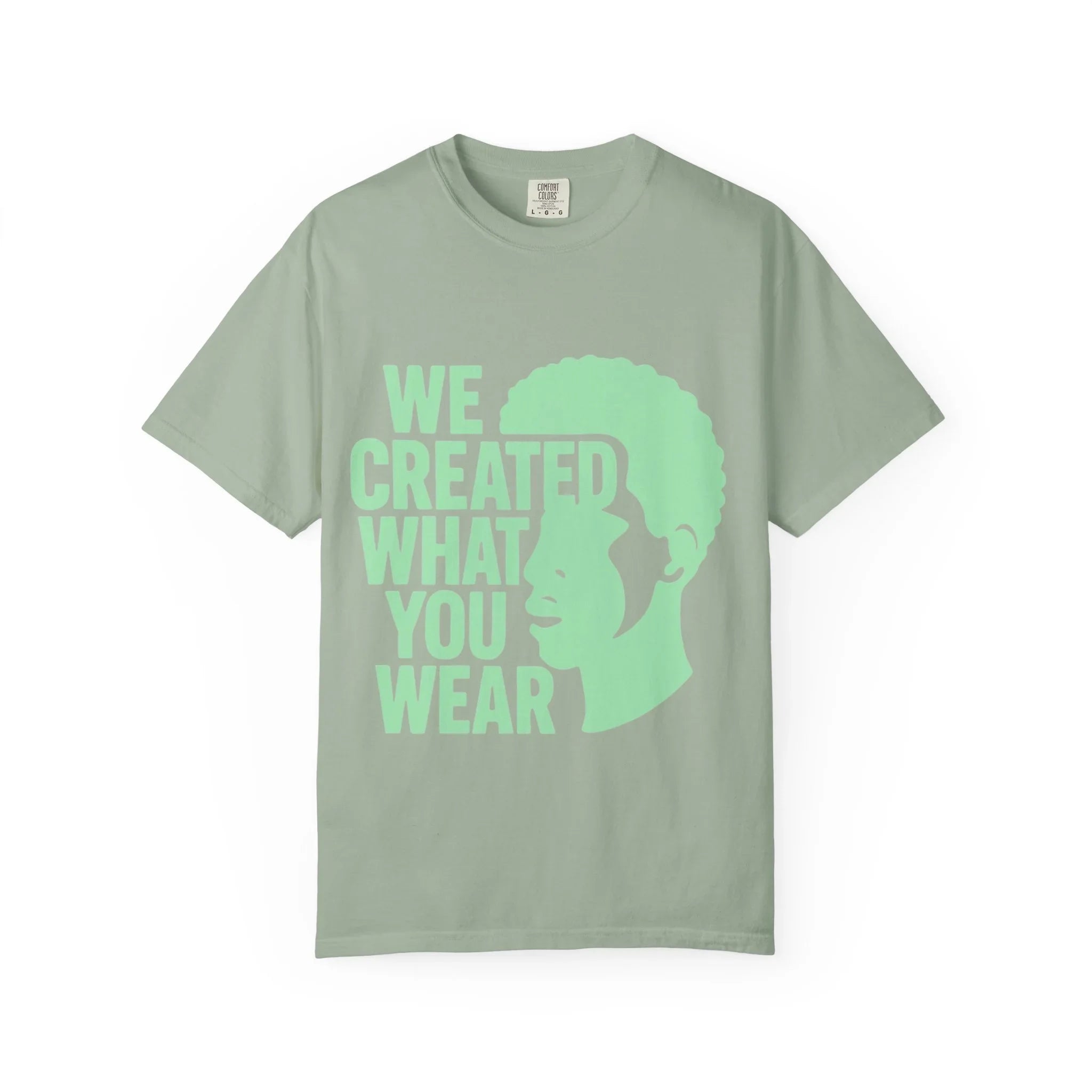 Green t-shirt with 'WE CREATED WHAT YOU WEAR' text and silhouette design