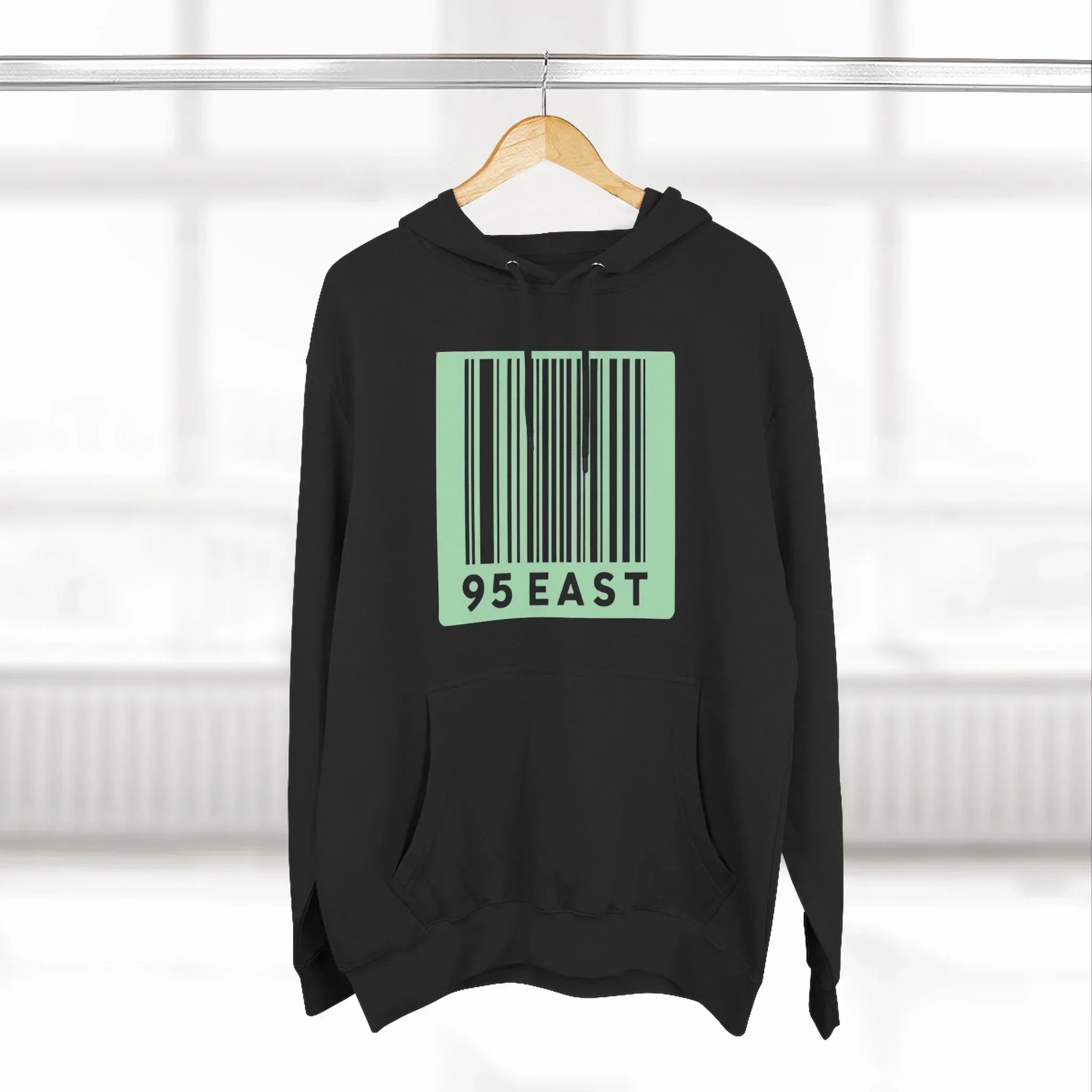 Black hoodie with green barcode design and 95 EAST text, modern East Coast style apparel