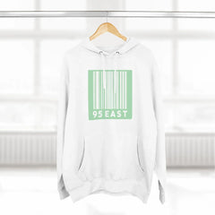 White hoodie with green barcode design and 95 EAST text, hanging on wooden hanger