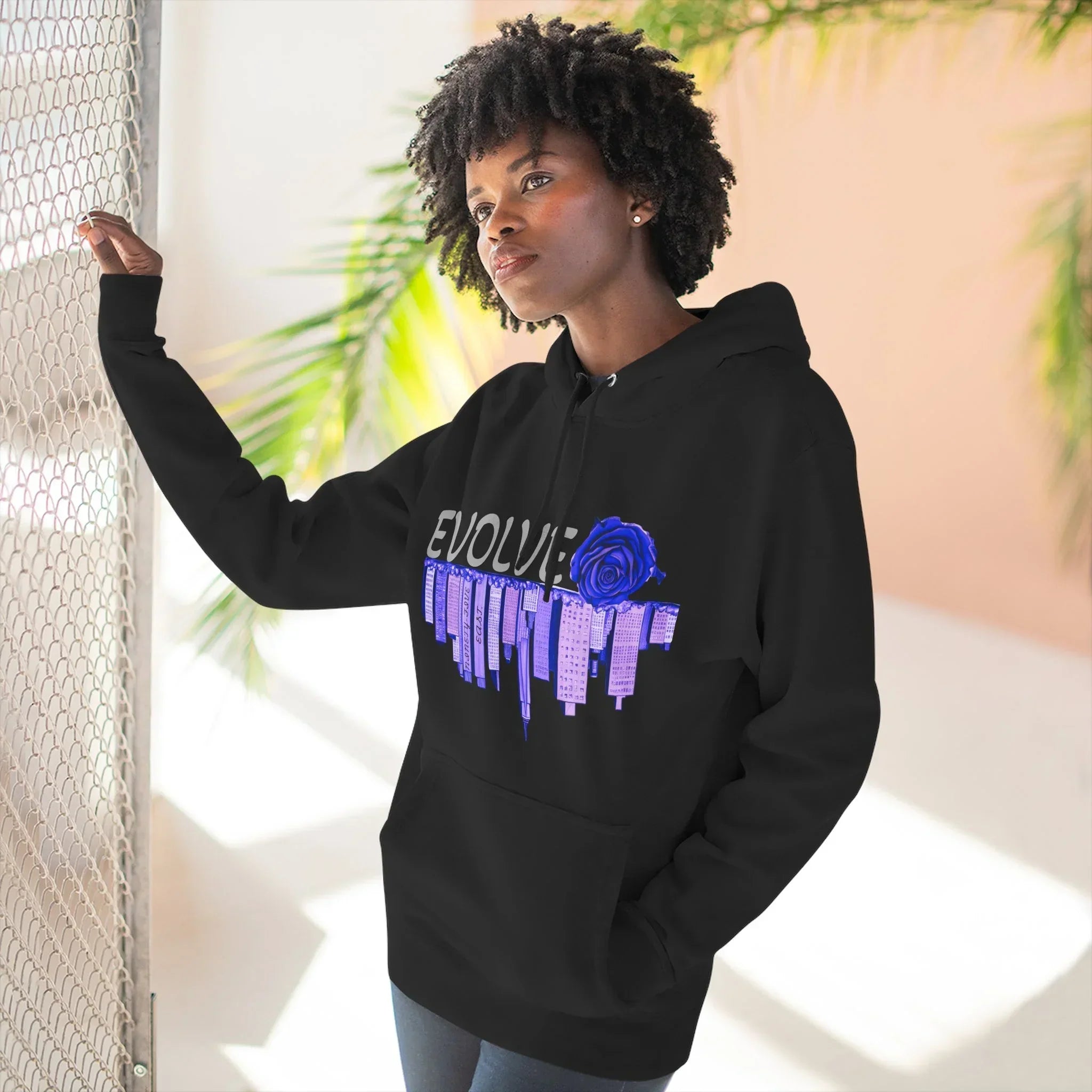 Black hoodie with blue rose graphic and city skyline, featuring 'EVOLVE' text and barcode sleeve detail