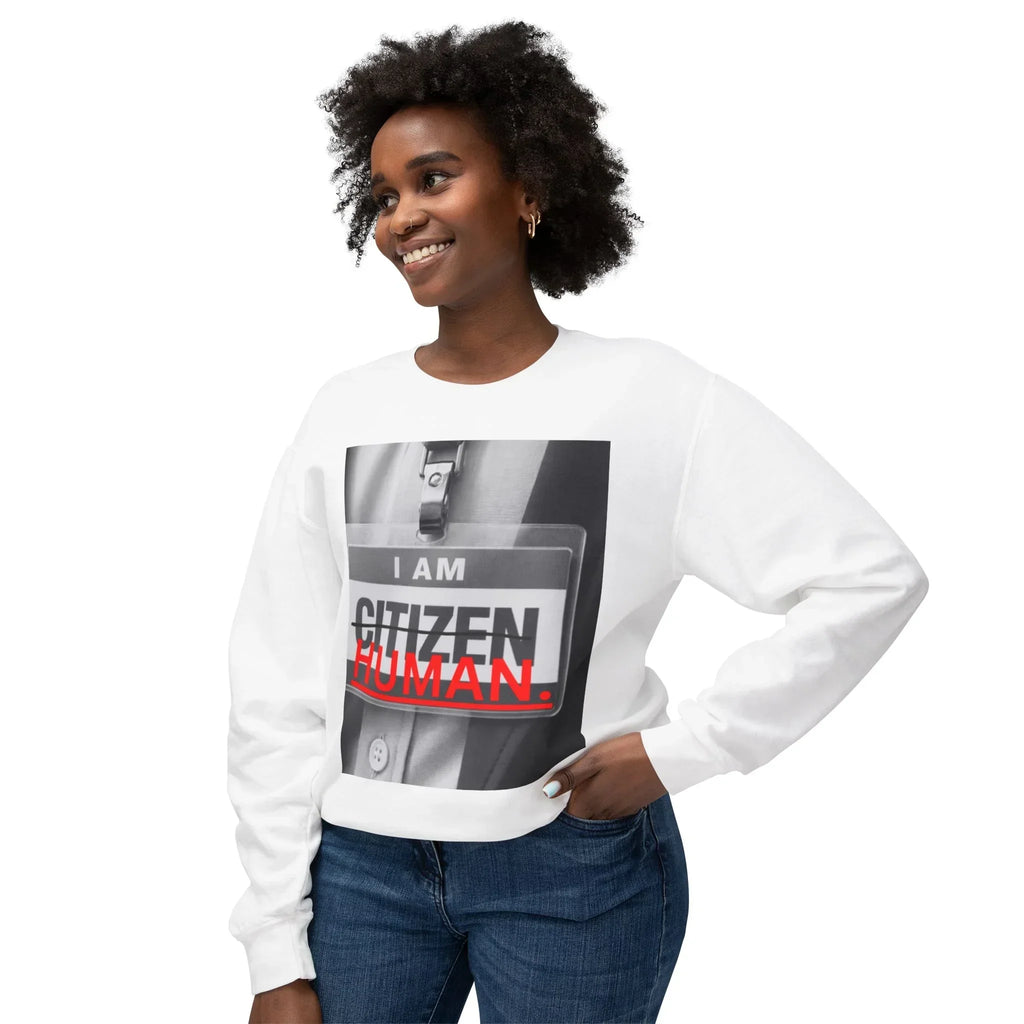 Smiling woman in white sweatshirt with bold graphic text reading 'I AM HUMAN'